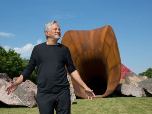 Anish Kapoor poses in front of his artwork named'Dirty Corner' at the opening of his exhibition of his works in the gardens of the Chateau de Versailles. Anish Kapoor's exhibition at Palace of Versailles. Versailles, FRANCE-05/06/2015./MEIGNEUX_meigneuxA022/Credit:ROMUALD MEIGNEUX/SIPA/1506051851