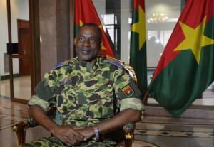 General Gilbert Diendere sits at the presidential palace in Ouagadougou, on September 17, 2015 after Burkina Faso's presidential guard declared a coup, a day after seizing the interim president and senior government members, as the country geared up for its first elections since the overthrow of longtime leader Blaise Compaore. Diendere, Compaore's former chief of staff, was appointed head of a governing council, which announced a nighttime curfew and shut down the borders. AFP PHOTO / AHMED OUOBA