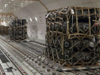 In this image provided by the U.S. Air Force, Senior Airman Cameron Manson, 436th Aerial Port Squadron ramp services load team chief, inspects cargo netting on palletized ammunition, weapons and other equipment bound for Ukraine during a foreign military sales mission at Dover Air Force Base, Del., on Jan. 24, 2022. Since 2014, the United States has committed more than $5.4 billion in total assistance to Ukraine, including security and non-security assistance. (Roland Balik/U.S. Air Force via AP)