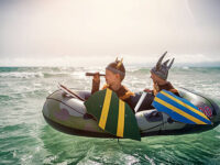 Two fearsome little vikings are looking for someone to raid. Two boys aged 6 are playing vikings at sea,